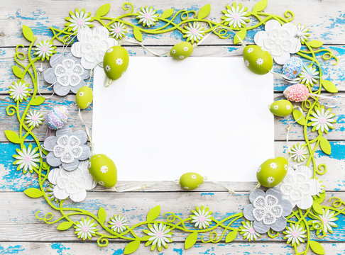 Blank sheet with easter decorations on the wooden background. Easter greeting card.