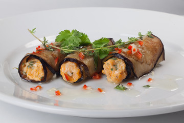 Rolls of eggplant with cheese and greens, sweet pepper, close-up isolated for menu