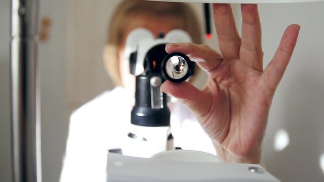 Healthcare - optometrist - doctor ophthalmology examining patient's eyes - medical concept