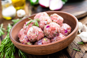 Raw meatballs close-up on wooden background