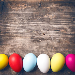 Easter Eggs on old boards. Painted eggs. Old board background. Easter ideas. Easter eggs. Space for text. Image in trendy toning.