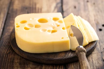 Dekokissen Delicious Swiss yellow cheese on dark wooden rustic background closeup © Sea Wave