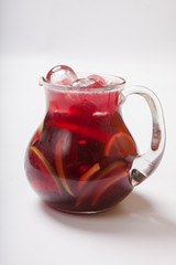 Sangria in pitcher with slices of fruit and ice, selective focus