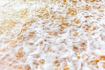 Sea foam on the sand