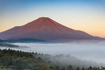 Mountain Fuji without snow cover the peak and sea of mist below in early autumn
