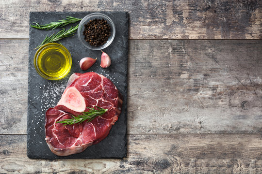 Raw meat and ingredients on wooden background
