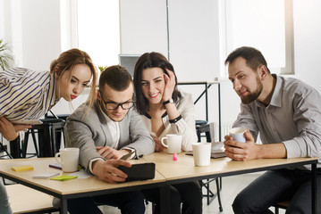 Group of creative young people in the office makes selfie