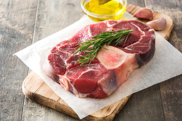 Raw meat and ingredients on wooden background
