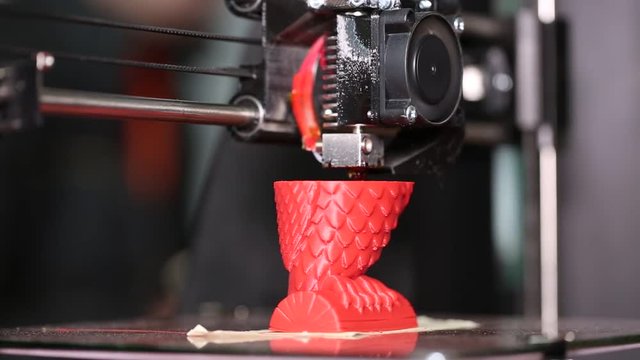 3d printer is typing 3d model of a red owl. The video is shot close-up. This video was shot using Canon 5d Mark 3. If you liked this video, rate it, please!