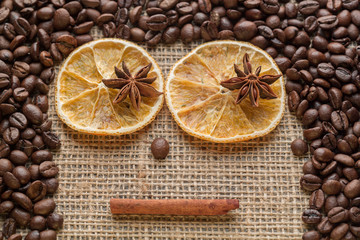 Coffee beans and illicium on a background of burlap. Roasted coffee beans background close up. Coffee beans pile from top with copy space for text. Seasoning. Spice. Badian. Coffee house.