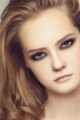 Vintage style portrait of young beautiful girl with smoky eyes make-up