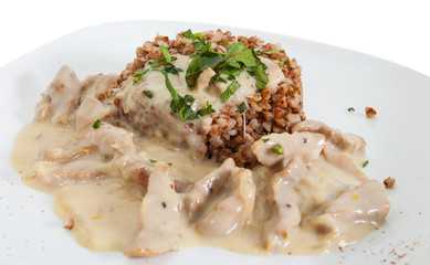 Beef Stroganoff. Beef with sour cream and garnish of buckwheat  isolated on white