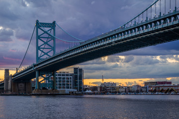 The Benjamin Franklin Bridge and and Delaware River at sunset, seen from Camden, New Jersey.