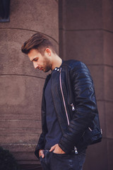 Fashion portrait of the young beautiful man in jacket