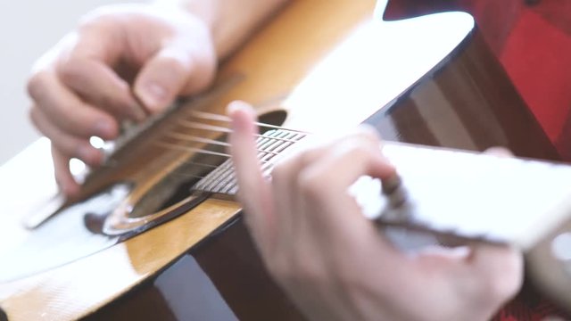 Hipster guy plays acoustic guitar. Music, Sound, Band, Concept.
