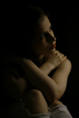 Fototapeta na wymiar Studio portrait of a beautiful brunette on a black background