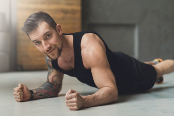 Fototapeta na wymiar Young man fitness workout, elbow plank