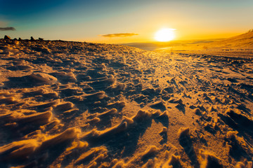 Golden sunset at winter tundra's road, Kola Peninsula, Russia