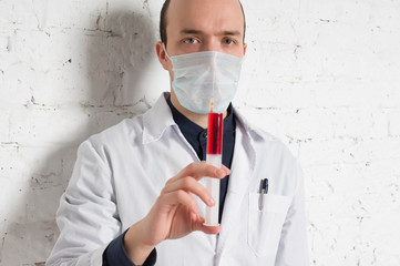 Doctor holds in a hand syringe inside the injection of vitamin