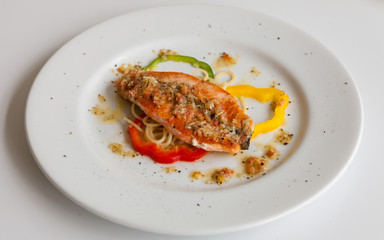 Salmon steak on white dish isolated, Top view.