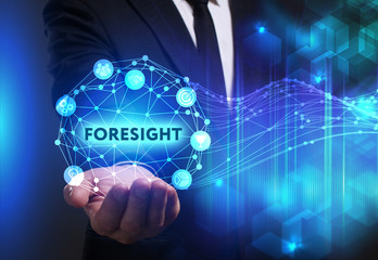 Fototapeta premium Business, Technology, Internet and network concept. Young businessman working on a virtual screen of the future and sees the inscription: Foresight