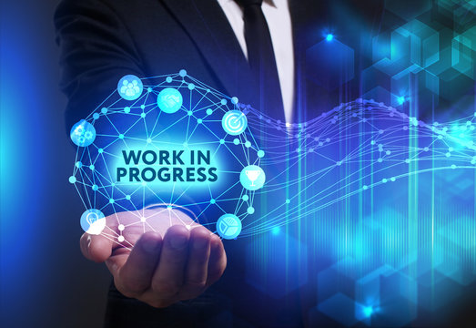 Business, Technology, Internet and network concept. Young businessman working on a virtual screen of the future and sees the inscription: Work in progress