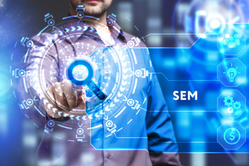 Business, Technology, Internet and network concept. Young businessman working on a virtual screen of the future and sees the inscription: SEM