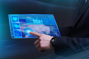 Business, Technology, Internet and network concept. Young businessman working on a virtual screen of the future and sees the inscription: SCM