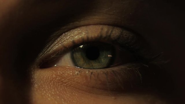 Extreme close up human eye iris in 4K UHD video. Human eye iris contracting. Extreme close up. 4K UHD 2160p footage.
