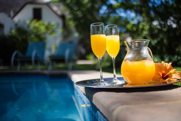 Close up image of a jug of juice and two champagne glasses at an upmarket guesthouse