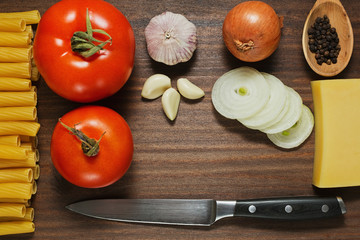 Pasta ingredients laid out on the wooden table