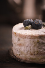 Cake with blueberries on the wooden table vertical