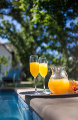 Close up image of a jug of juice and two champagne glasses at an upmarket guesthouse