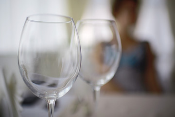 glasses on the table serving restaurant light background girl