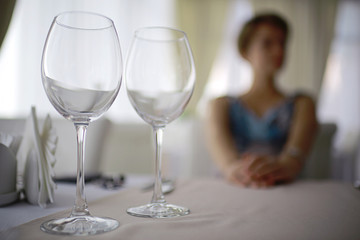 glasses on the table serving restaurant light background girl