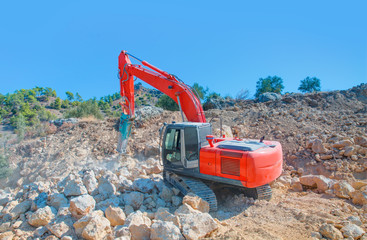 Large jackhammer smashing rocks