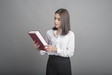 Fototapeta premium Beautiful teacher Woman holding book on grey background