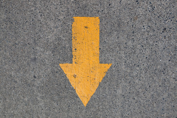 Yellow asphalt sign, arrow