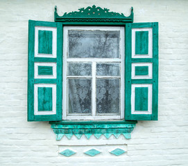 Fototapeta premium authentic old wooden window with carved shutters