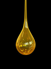 Oil drop isolate on Black background,golden oil