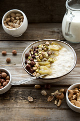 Oatmeal with caramelized bananas and nuts. The concept of healthy breakfast 
