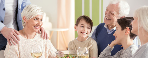 Smiling mother with kids during dinner