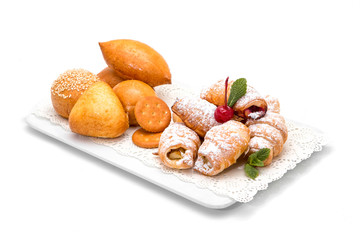 Croissants in powdered sugar with crackers and buns