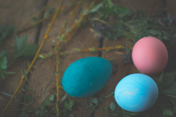 Colored easter eggs on wooden background.