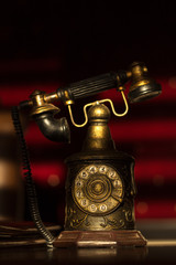 Old retro telephone with receiver and numbers still life on red background
