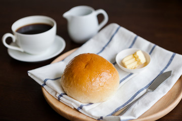 Homemade bread with cheese and a cup of coffee on wooden table. Shoot in close up shot.