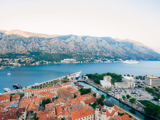 Naklejka na ściany i meble Liner on the dock in Kotor, near the Old Town in Bay of Kotor, Montenegro. The view from the observation deck over the city.