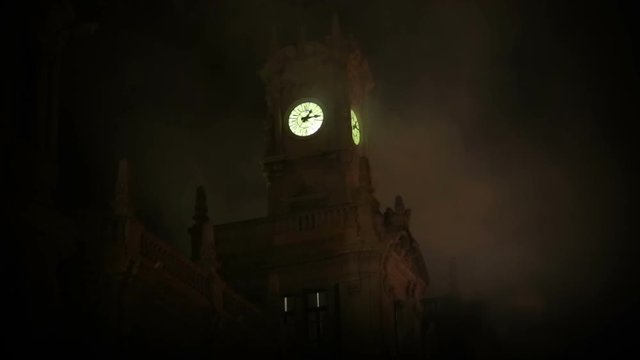 Smoky fog creepy clocktower in dark night rainstorm Halloween abstract