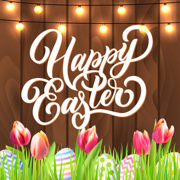 Happy Easter lettering with eggs, garland and tulip flowers in grass on rustic wooden background. Festive vector design. 