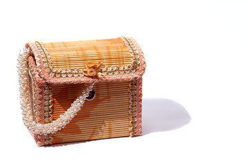 Bamboo box for storing jewelry. Casket with a pearl necklaces. Beads from pearls. Isolated.